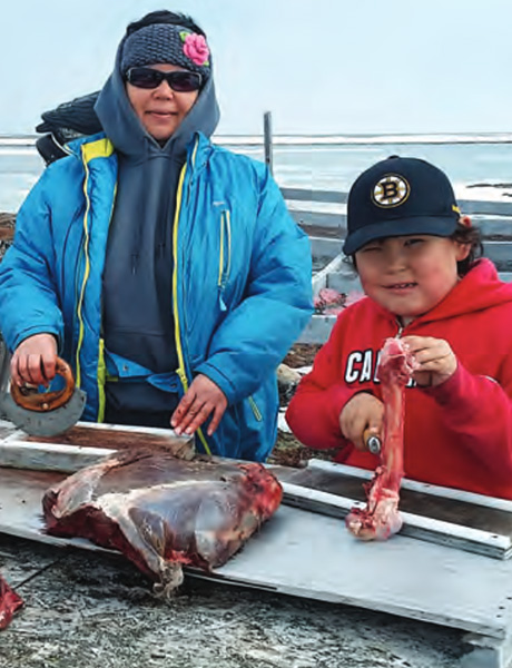 Arctic-Conservation-Series-Cover Janet Ishalook and her son Joabie cutting up caribou